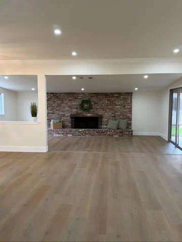 an empty room with a fireplace and painted walls