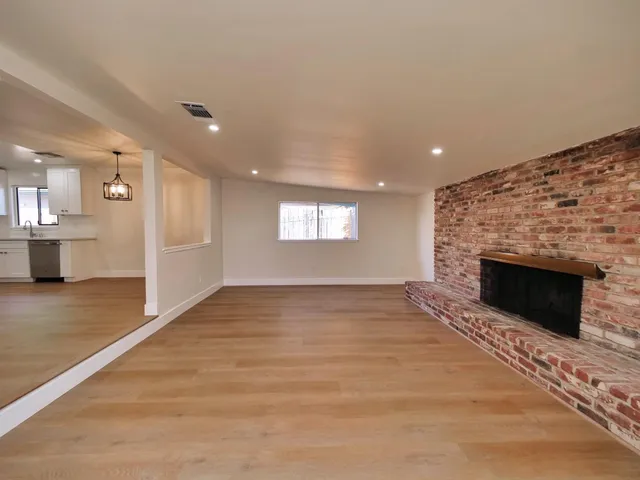a view of empty room with window and fireplace