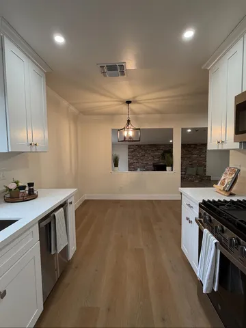 a kitchen that has a sink and a stove