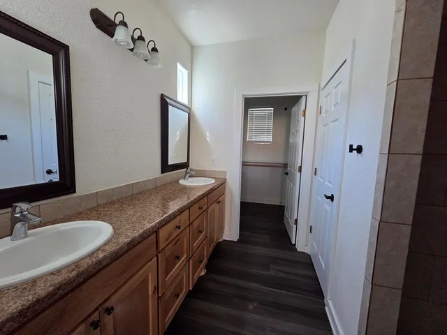 a bathroom with a sink double vanity and a mirror