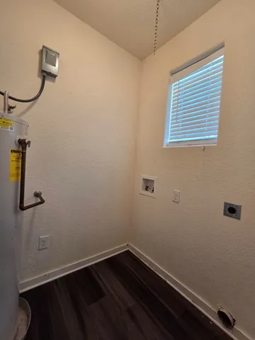 a view of a room with wooden floor and mirror