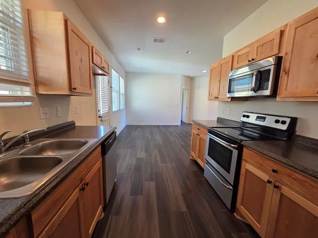 a kitchen that has a sink and a stove top oven