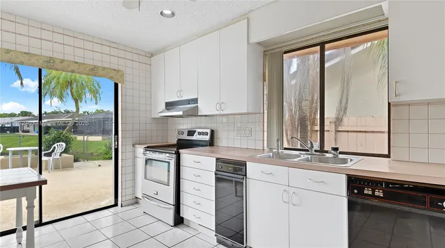 a kitchen with a sink and cabinets
