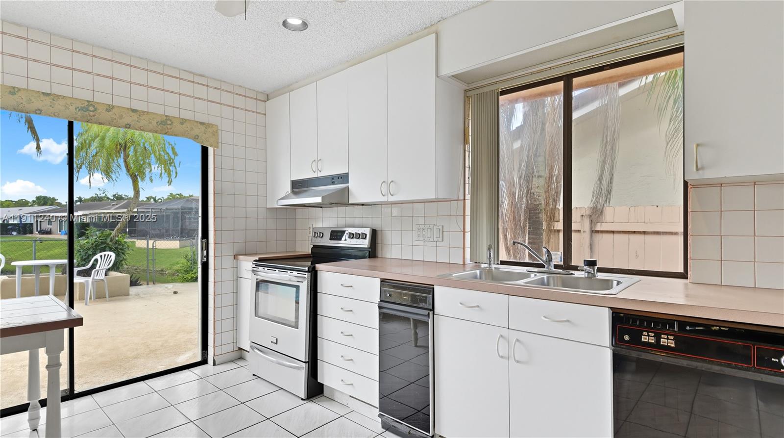 14604 Southwest 60th Terrace Miami, FL 33183 - Photo 17 of 55 a kitchen with a sink and white cabinets