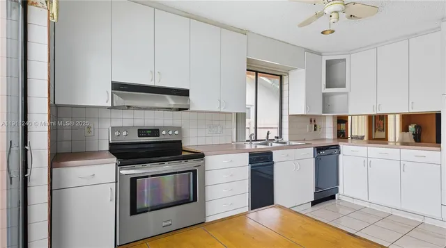 a kitchen with a table chairs and a window