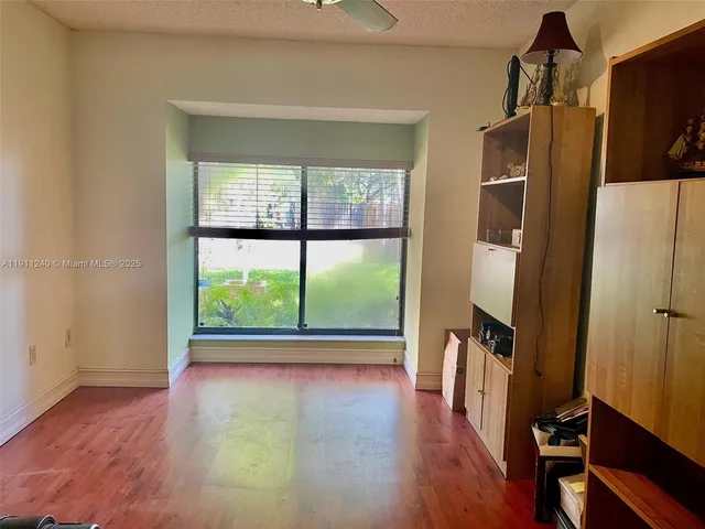 a bedroom with a bed dresser and a window
