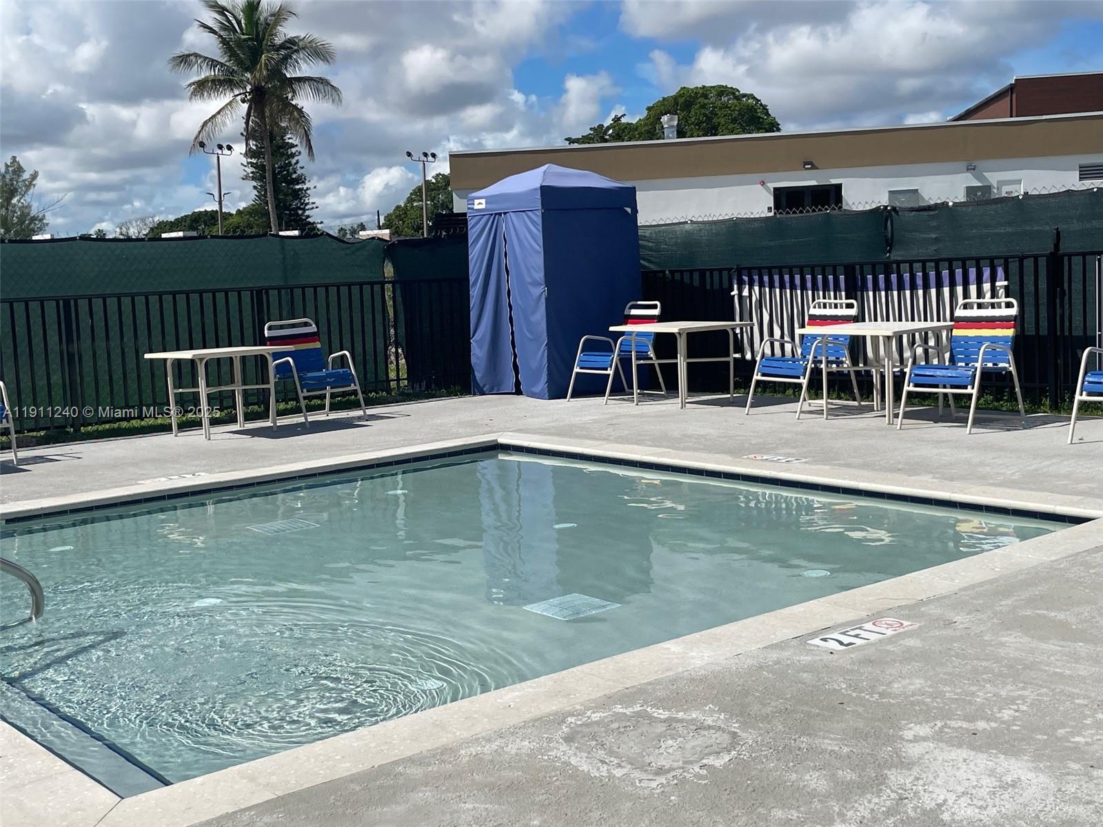 14604 Southwest 60th Terrace Miami, FL 33183 - Photo 32 of 55 a view of a swimming pool with a table and chairs