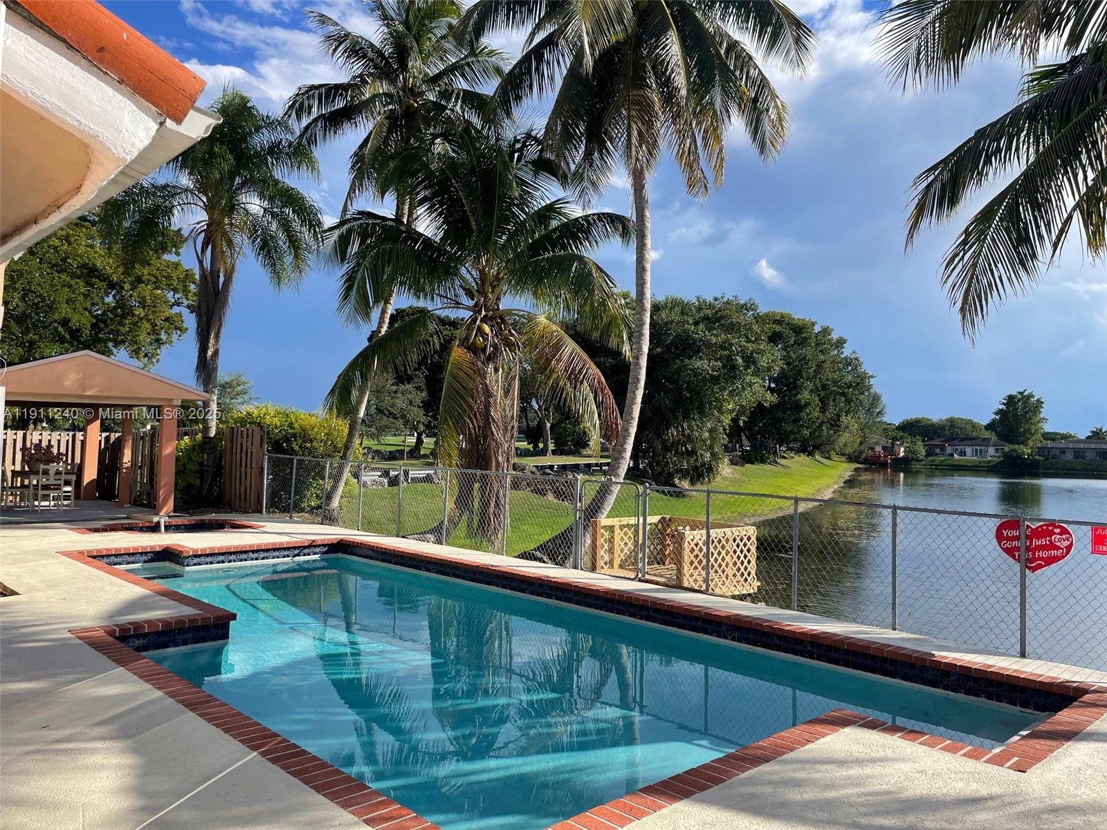 14604 Southwest 60th Terrace Miami, FL 33183 - Photo 39 of 55 a view of swimming pool with a table and chairs under an umbrella