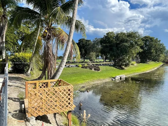 a view of swimming pool with a garden and trees