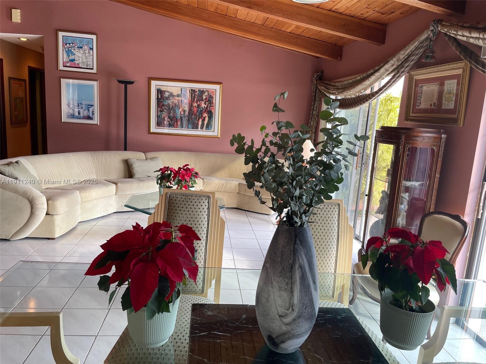 14604 Southwest 60th Terrace Miami, FL 33183 - Photo 43 of 55 a vase of flowers sitting on a table with a potted plant