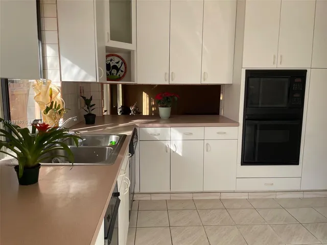 a dining room with furniture floor to ceiling window and outdoor view