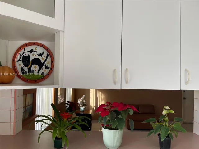 a view of a patio with a table and chairs and a barbeque