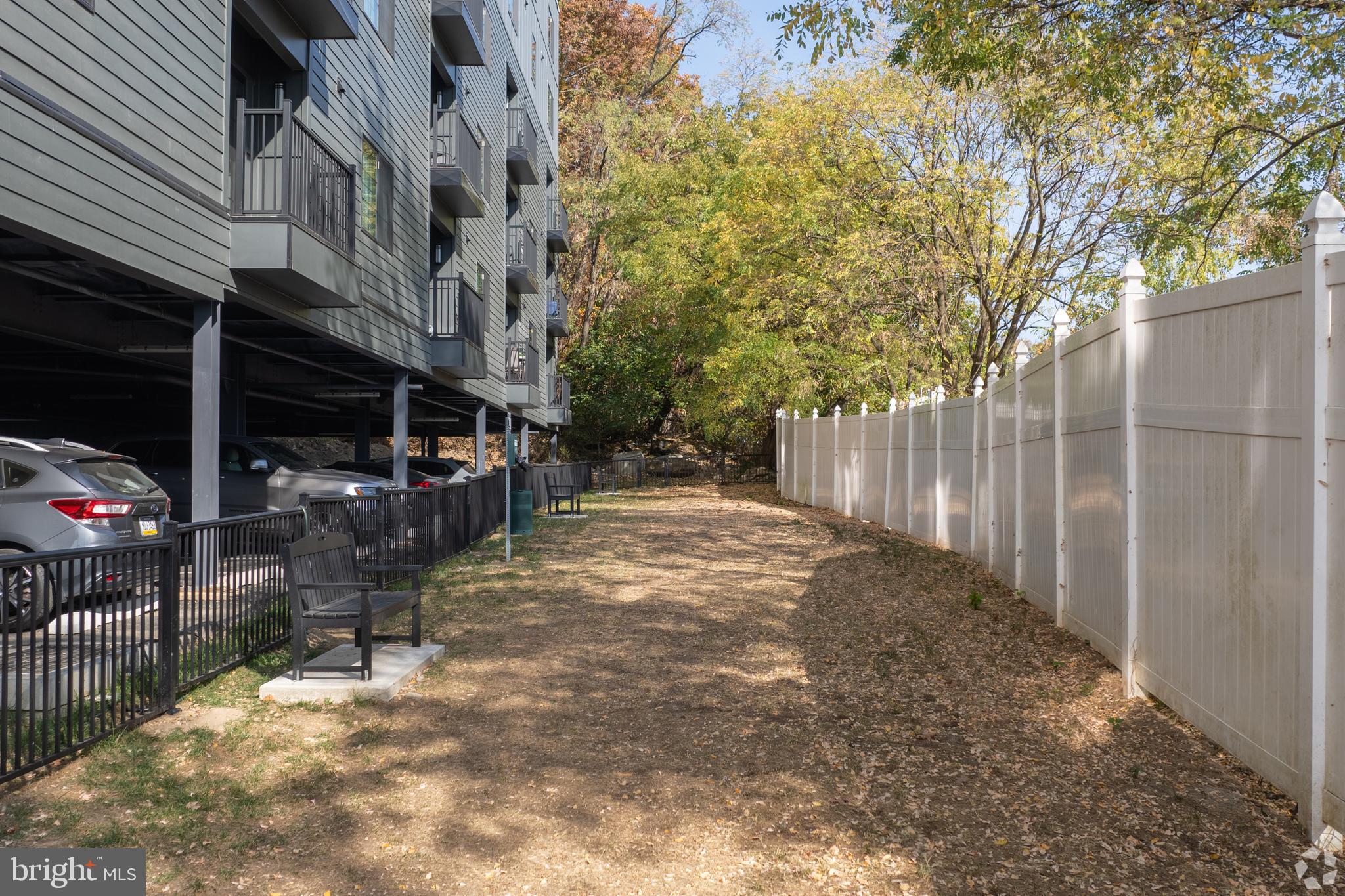 5001 Umbria Street, Unit P202 Philadelphia, PA 19128 - Photo 13 of 20 a view of backyard with sitting area and tree