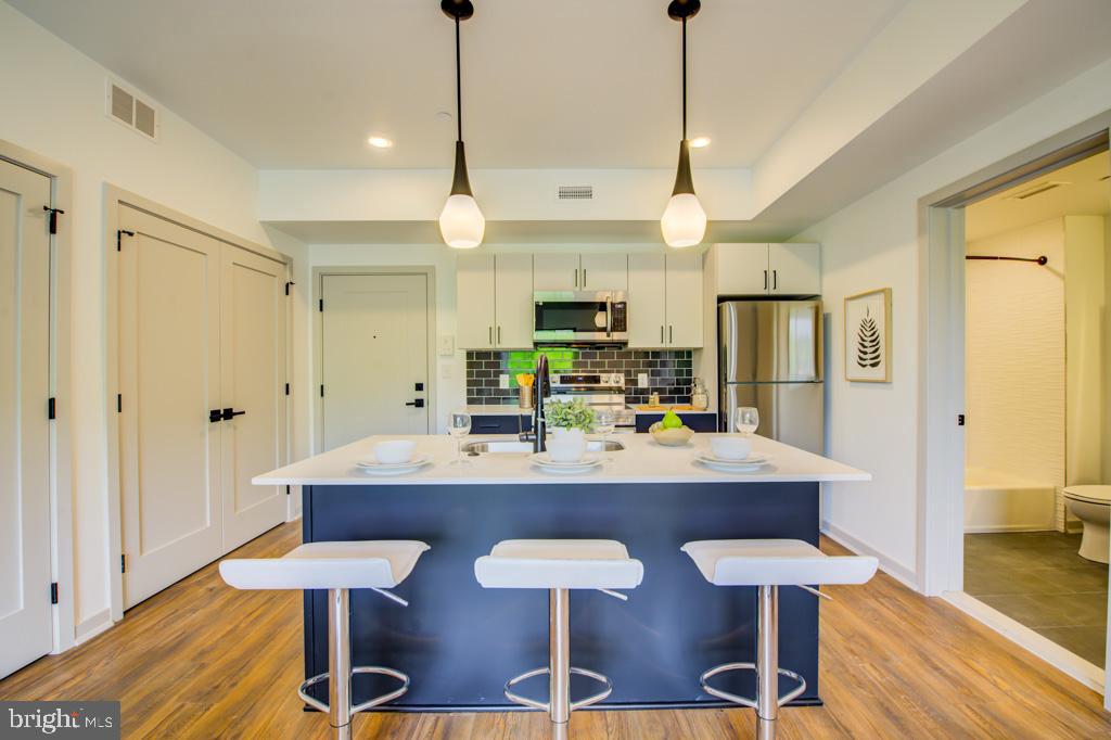 5001 Umbria Street, Unit P202 Philadelphia, PA 19128 - Photo 5 of 20 a view of a dining room with furniture