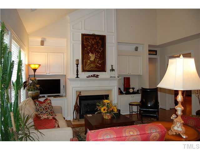 3733 Old Post Road Raleigh, NC 27612 - Photo 10 of 25 a living room with furniture a fireplace and a flat screen tv