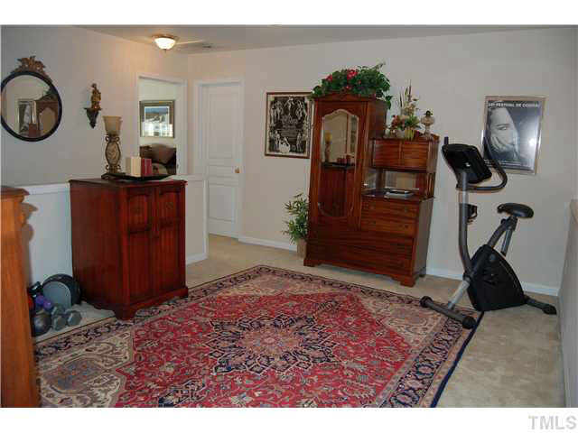 3733 Old Post Road Raleigh, NC 27612 - Photo 15 of 25 a bedroom with a bed and cabinets