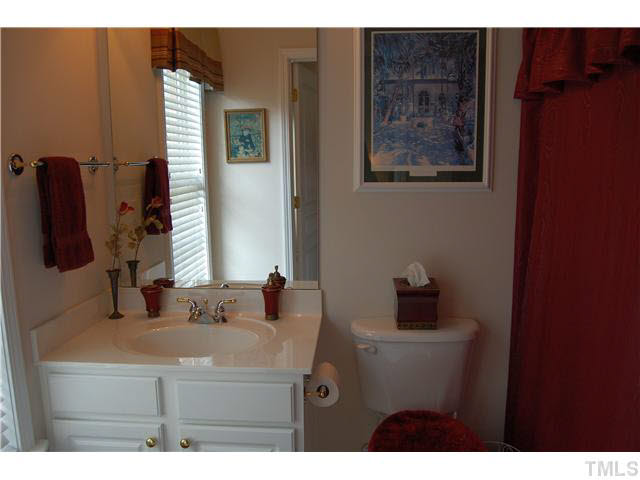 3733 Old Post Road Raleigh, NC 27612 - Photo 17 of 25 a bathroom with a sink and a mirror