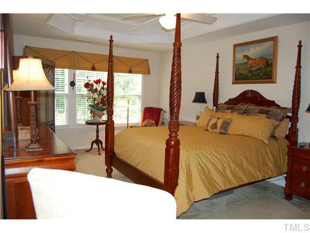 3733 Old Post Road Raleigh, NC 27612 - Photo 18 of 25 a bedroom with a bed a chandelier and large window