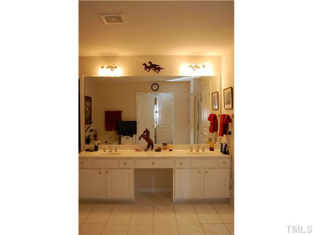 3733 Old Post Road Raleigh, NC 27612 - Photo 20 of 25 a bathroom with a sink and a mirror