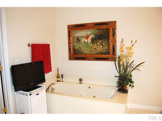 3733 Old Post Road Raleigh, NC 27612 - Photo 21 of 25 a bathroom with a bathtub and a picture