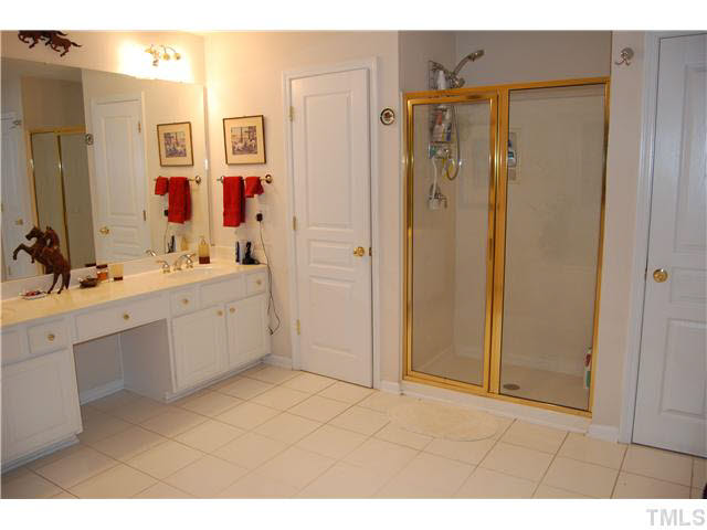 3733 Old Post Road Raleigh, NC 27612 - Photo 22 of 25 a bathroom with a double vanity sink a mirror a shower and a bathtub