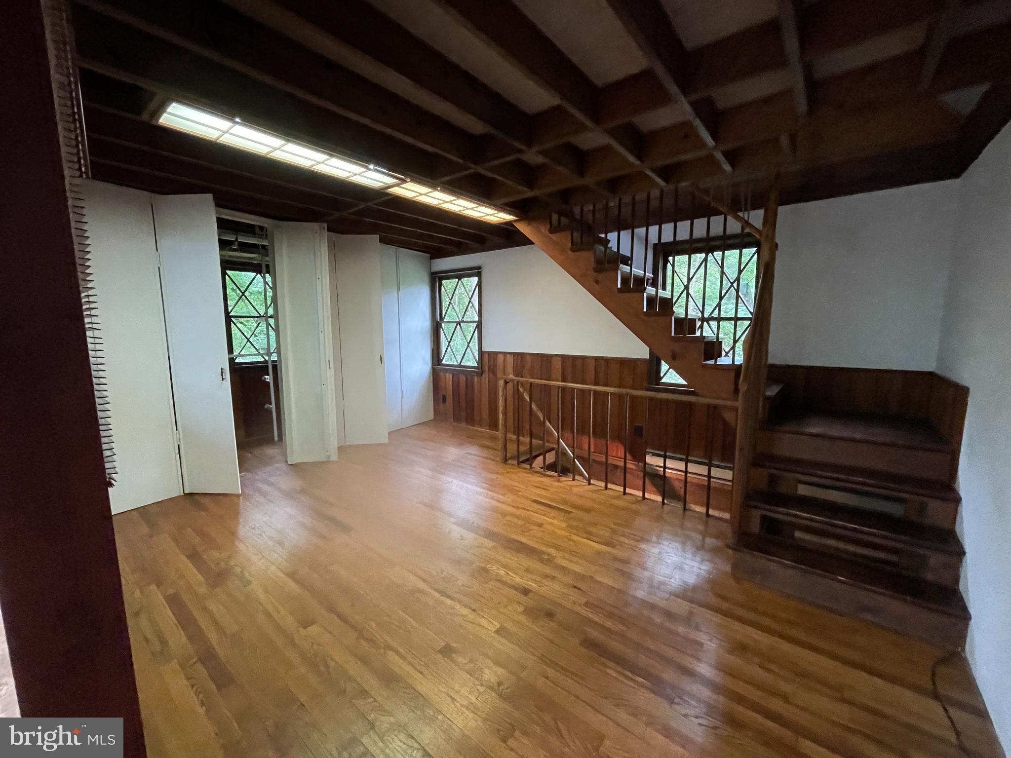 175 Howellsville Road Front Royal, VA 22630 - Photo 16 of 18 a view of an empty room with wooden floor stairs and a way to kitchen