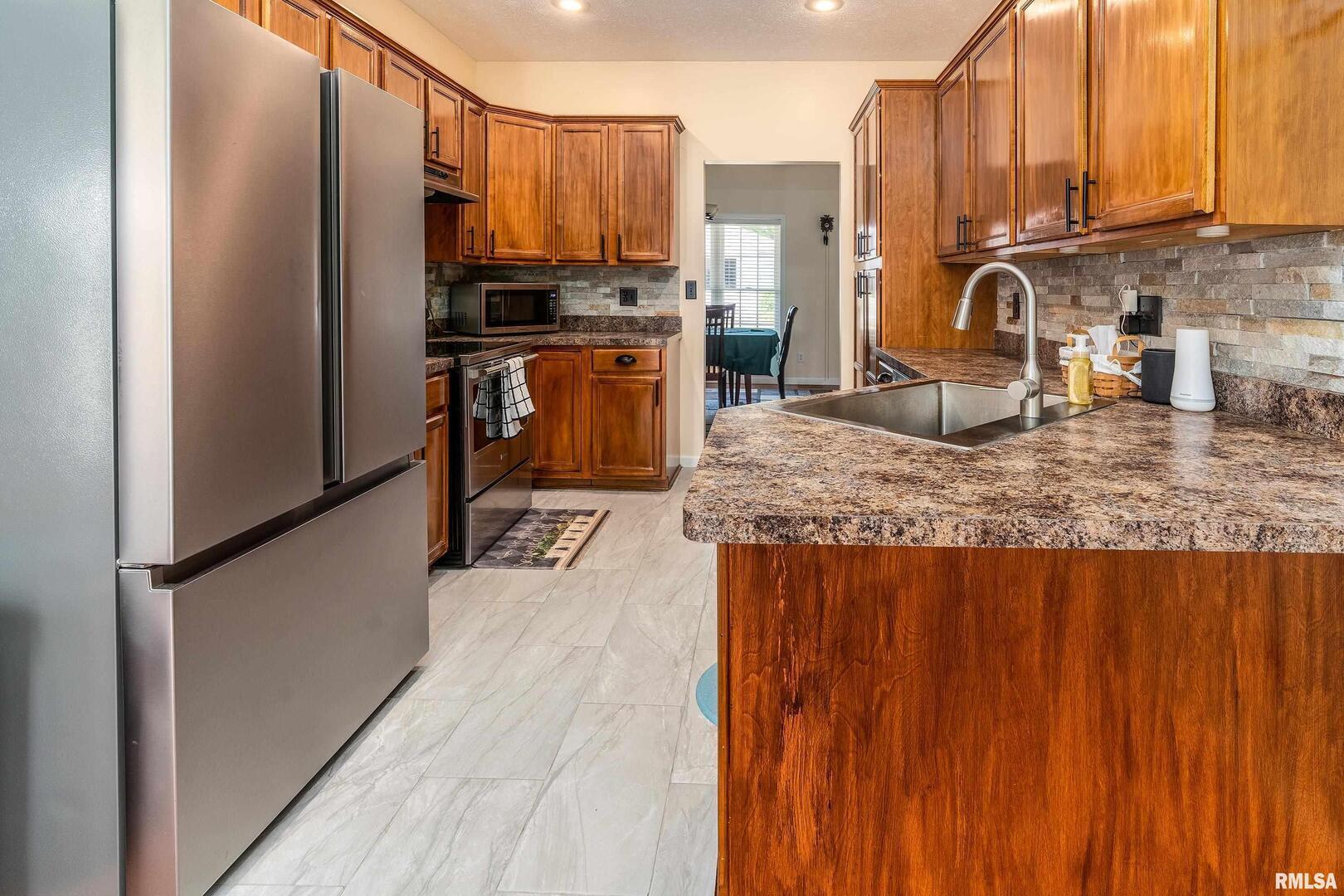 145 Oakview Road Carbondale, IL 62901 - Photo 11 of 42 a kitchen with kitchen island granite countertop a sink appliances cabinets and furniture
