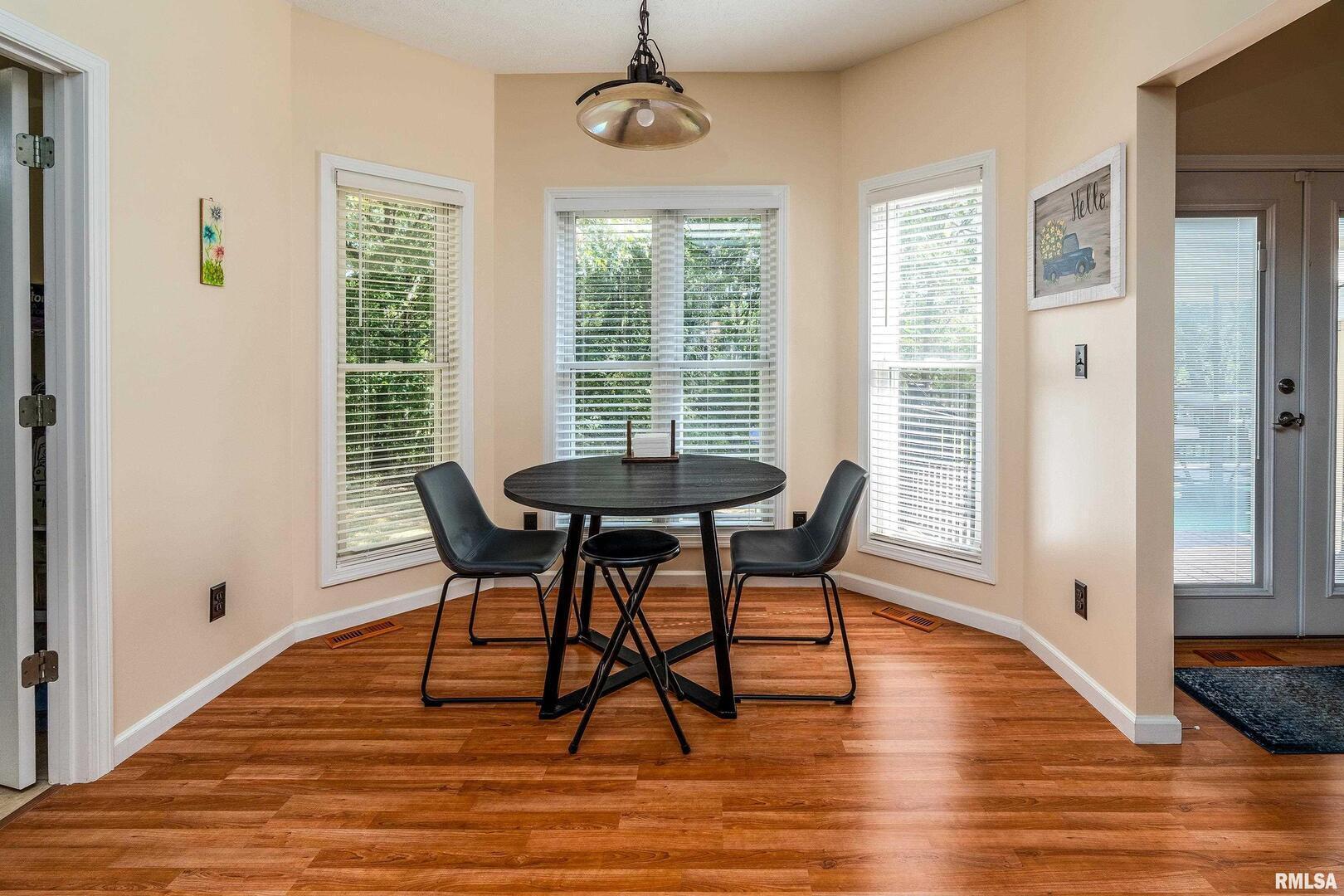 145 Oakview Road Carbondale, IL 62901 - Photo 12 of 42 a view of a dining room with furniture window and wooden floor