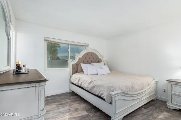 a bedroom with a bed and a dresser