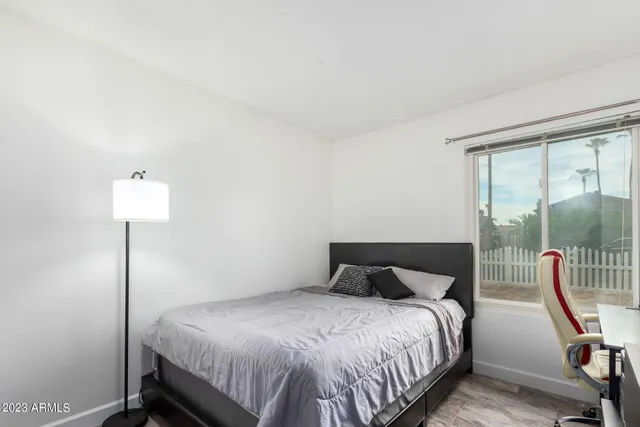 a bedroom with a bed and a lamp