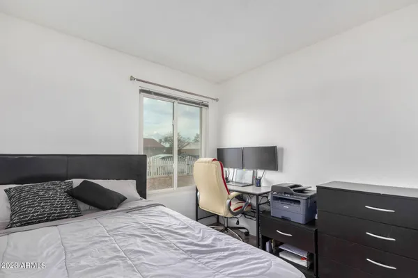 a bedroom with a bed and a desk