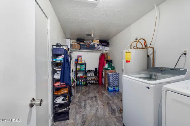a view of storage and utility room with washer and dryer