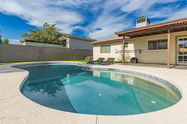 a view of a swimming pool with an outdoor seating