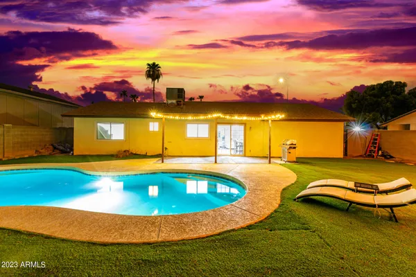 a view of a swimming pool with a table and chairs