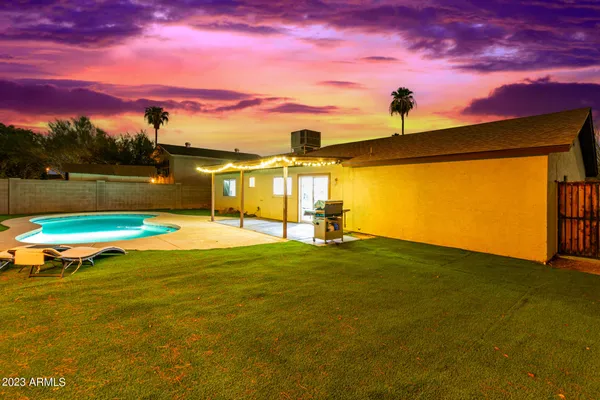 a view of a swimming pool with a yard