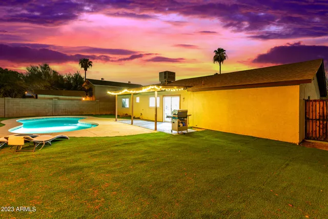 a view of a swimming pool with a yard
