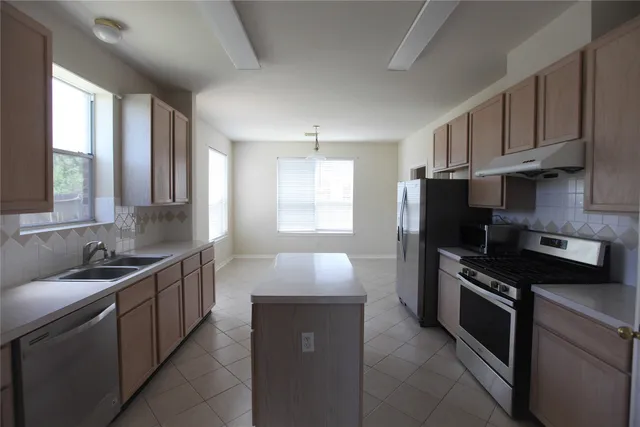 a kitchen with a sink stove and refrigerator