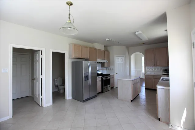 a view of a kitchen with refrigerator and stove
