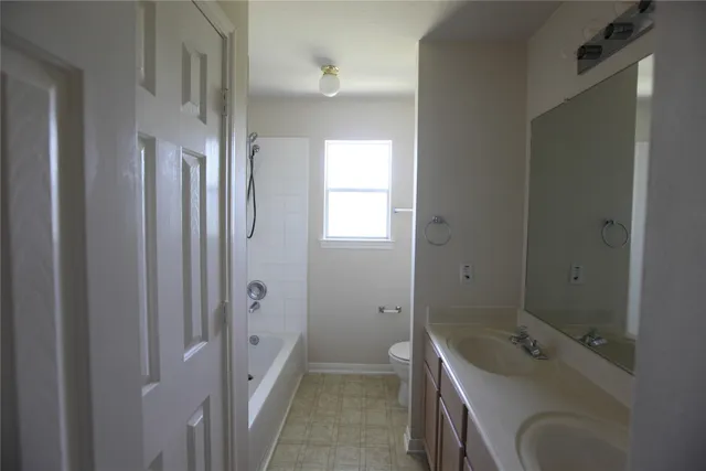 a bathroom with a tub sink and mirror