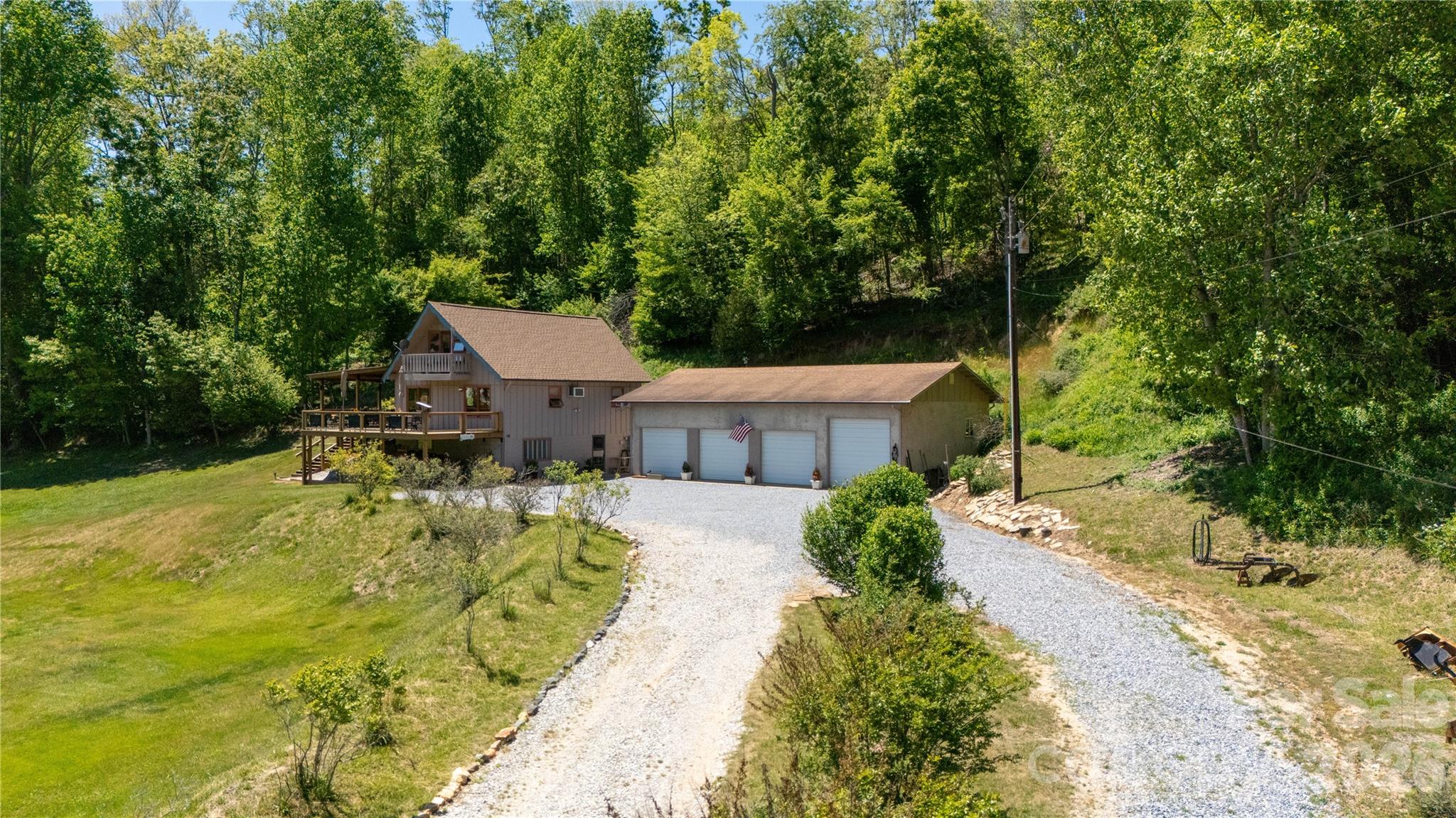 93 Franklin Crest Road Spruce Pine, NC 28777 - Photo 1 of 47 a view of a house with pool garden and sitting area