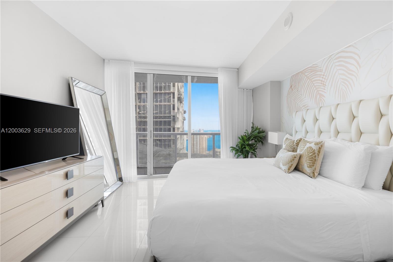 485 Brickell Avenue, Unit 4501 Miami, FL 33131 - Photo 15 of 49 a bedroom with a bed tv and a window