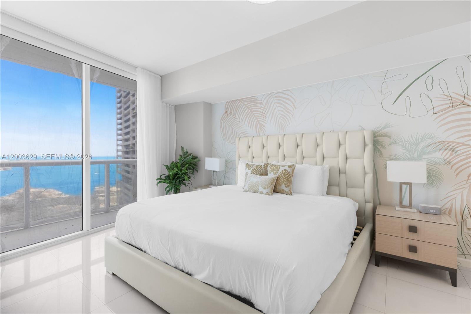 485 Brickell Avenue, Unit 4501 Miami, FL 33131 - Photo 16 of 49 a bedroom with a large bed and a chandelier