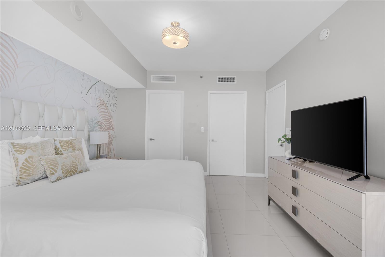 485 Brickell Avenue, Unit 4501 Miami, FL 33131 - Photo 17 of 49 a view of a bedroom with bed and flat screen tv