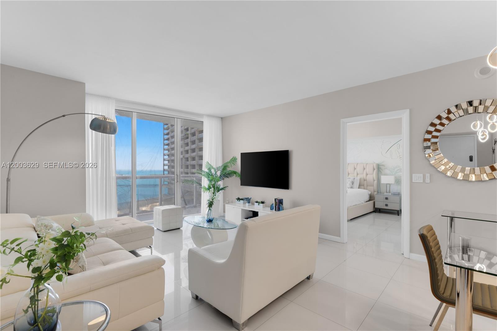 485 Brickell Avenue, Unit 4501 Miami, FL 33131 - Photo 2 of 49 a living room with furniture and a flat screen tv
