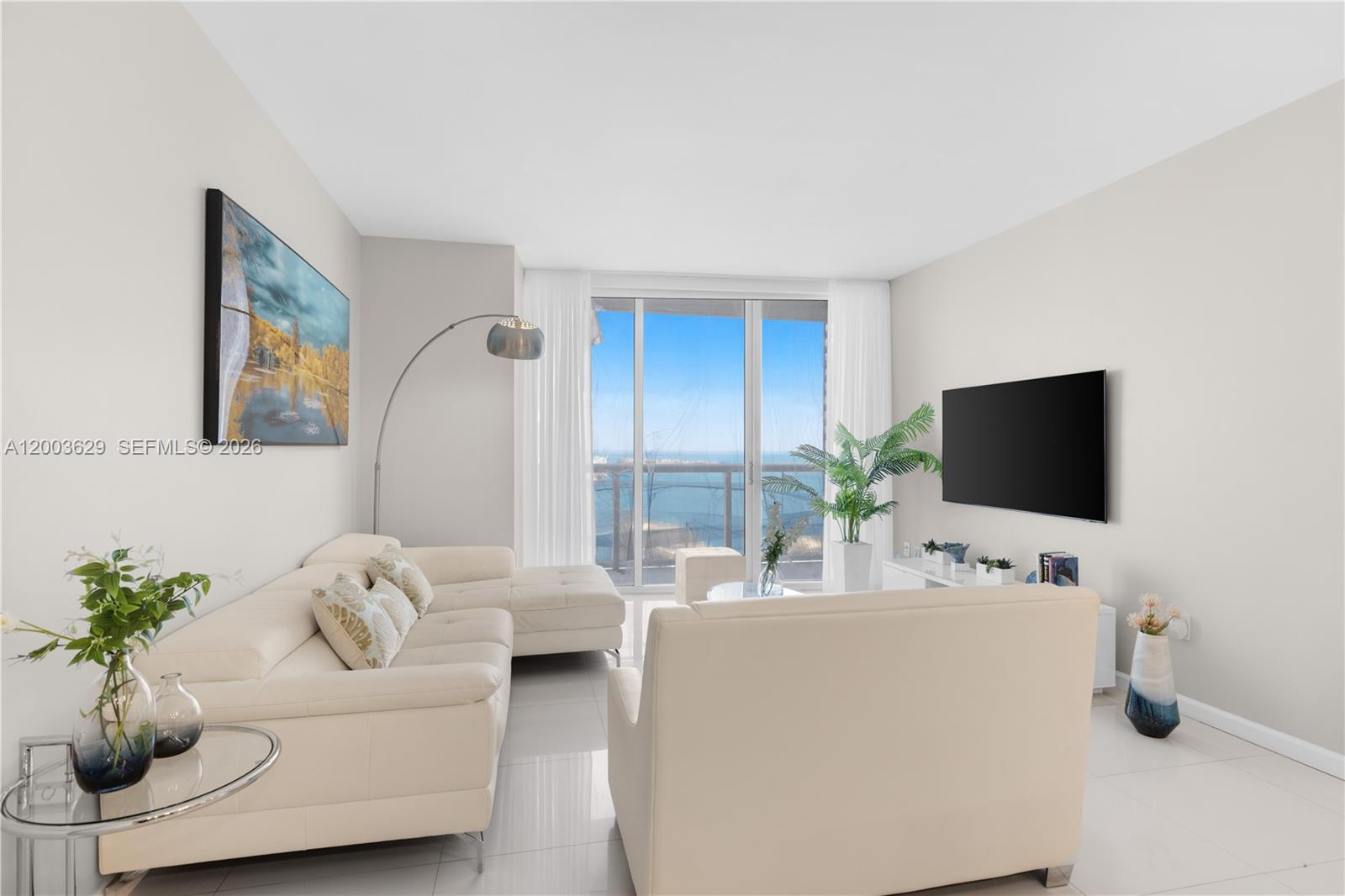 485 Brickell Avenue, Unit 4501 Miami, FL 33131 - Photo 3 of 49 a living room with furniture and a flat screen tv