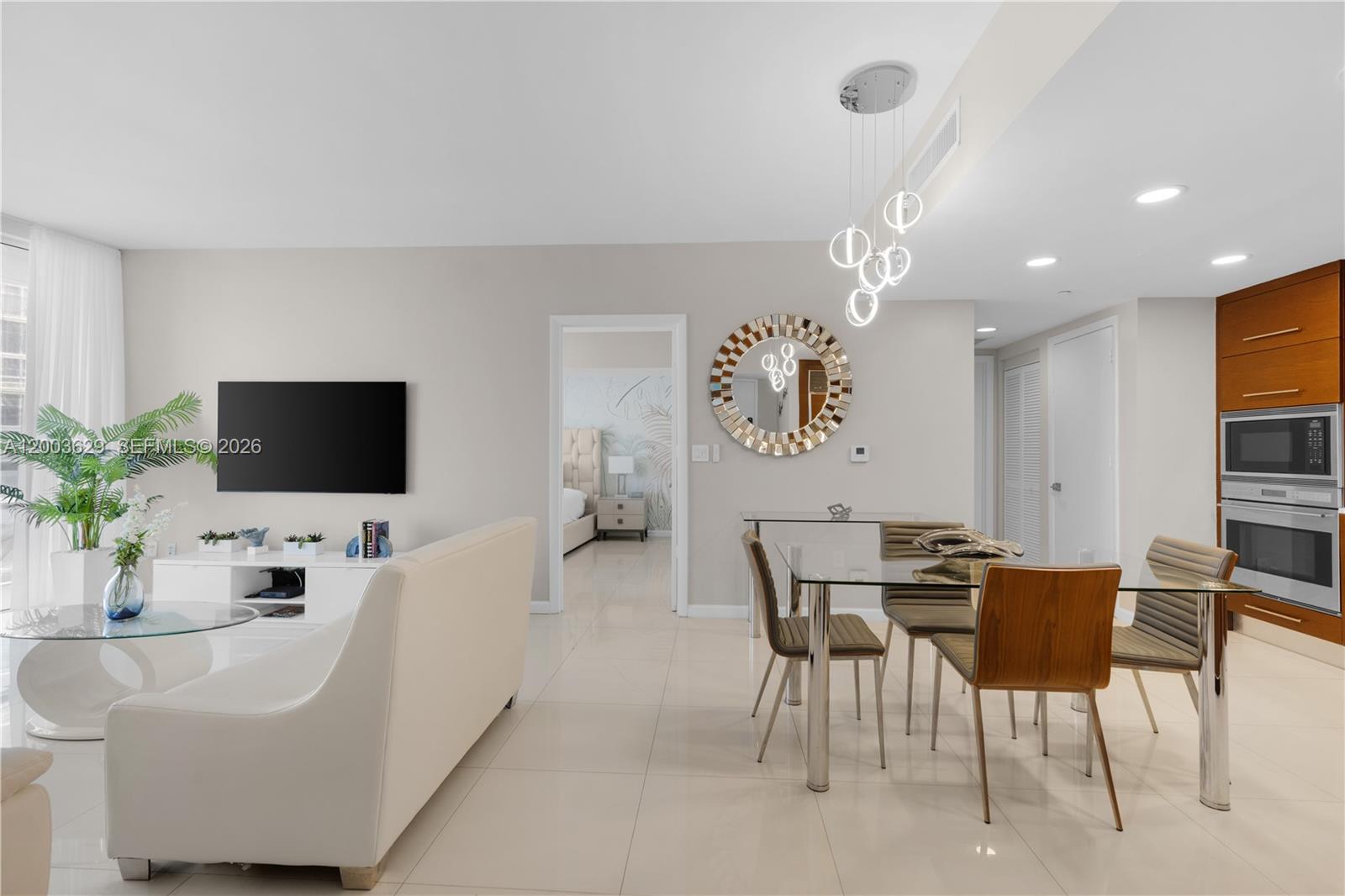 485 Brickell Avenue, Unit 4501 Miami, FL 33131 - Photo 4 of 49 a living room with furniture and a flat screen tv
