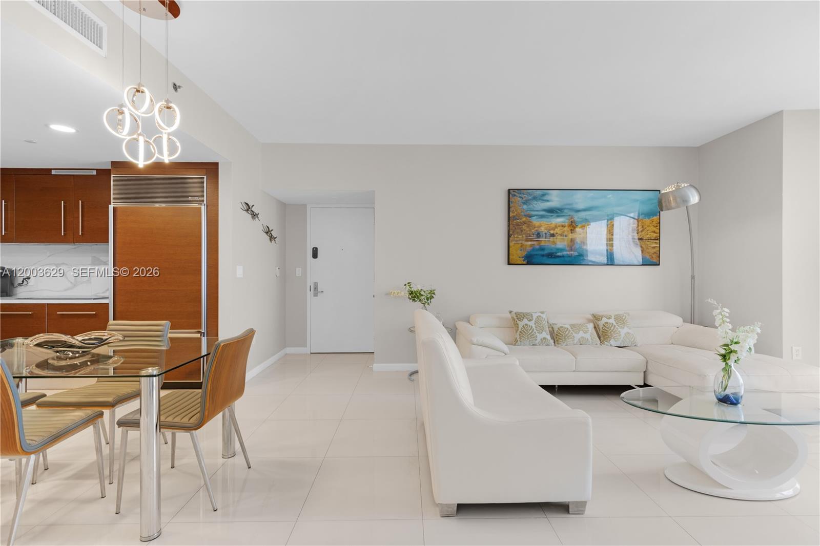485 Brickell Avenue, Unit 4501 Miami, FL 33131 - Photo 5 of 49 a living room with furniture a chandelier and a dining table