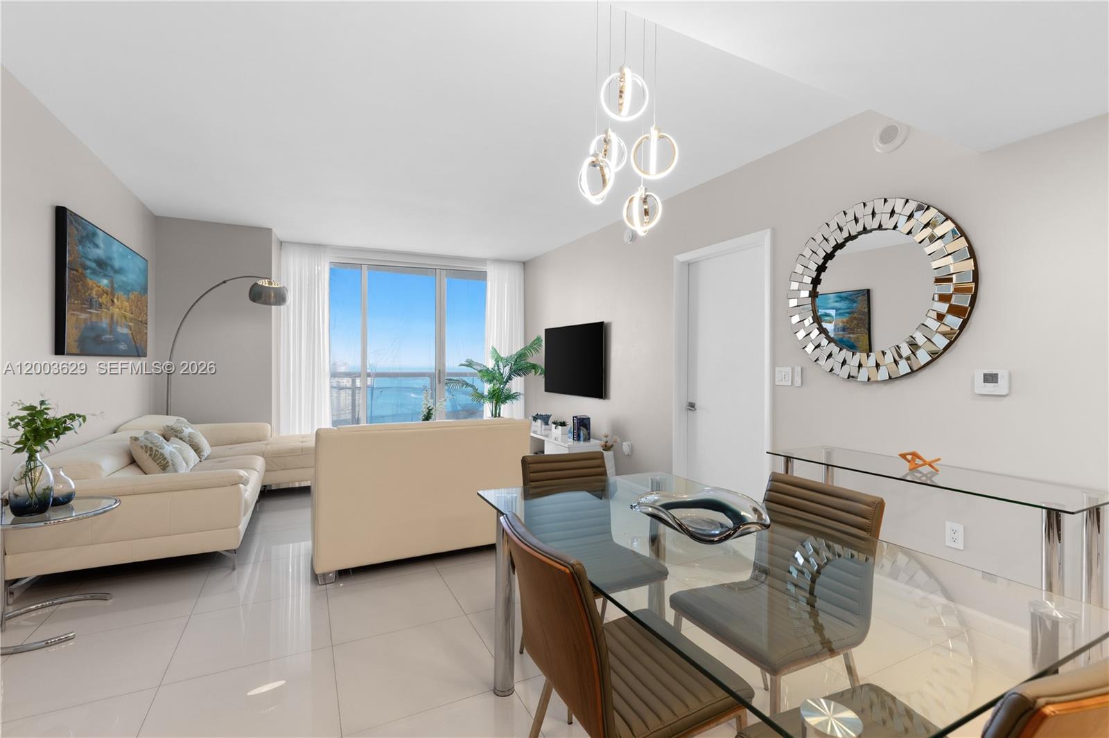485 Brickell Avenue, Unit 4501 Miami, FL 33131 - Photo 6 of 49 a living room with furniture a couch and a flat screen tv