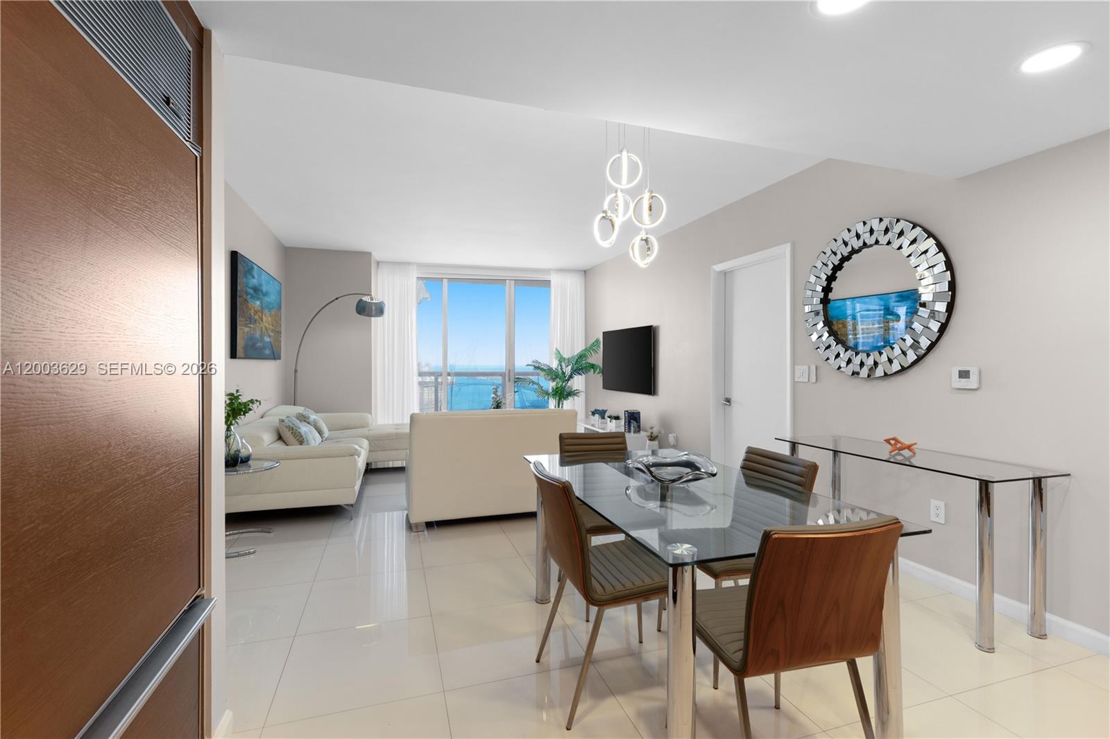 485 Brickell Avenue, Unit 4501 Miami, FL 33131 - Photo 7 of 49 a living room with furniture and a wall painting
