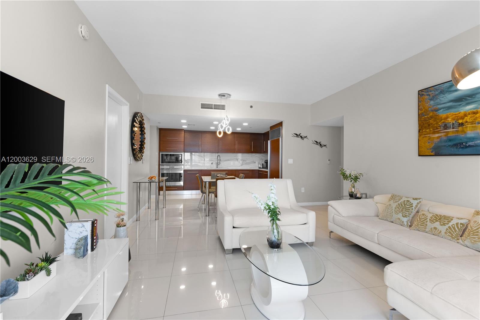 485 Brickell Avenue, Unit 4501 Miami, FL 33131 - Photo 9 of 49 a living room with furniture and a flat screen tv